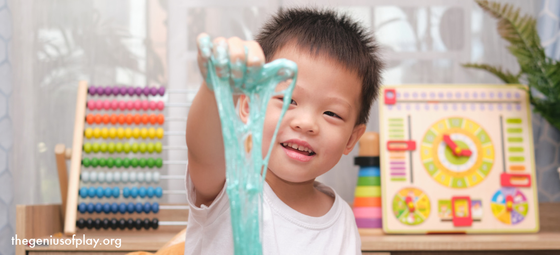 Young Asian boy having being creative and having fun with homemade slime playdough.