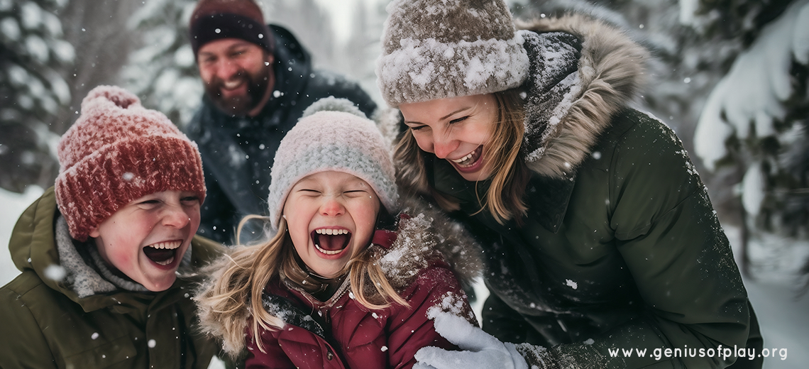 mother, father, young son and daughter smiling and playing outdoors in the snow 