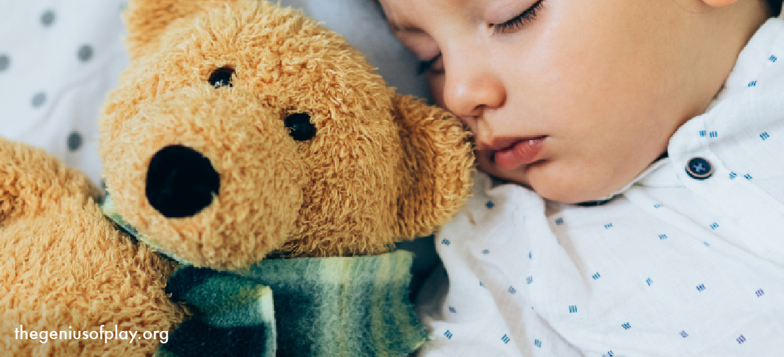 young toddler girl sleeping in bed with teddy bear 