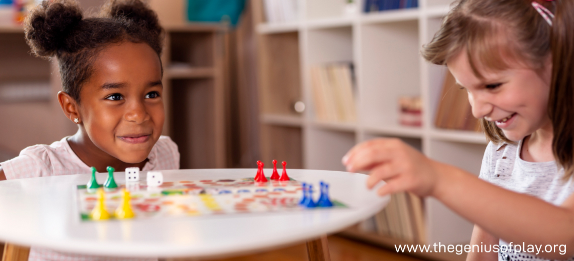 two young girls playing a board game