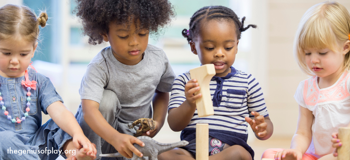 Diverse group of toddlers playing with blocks in a playroom