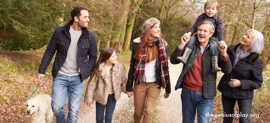 multi generational family walking outdoors in the cool weather with dog