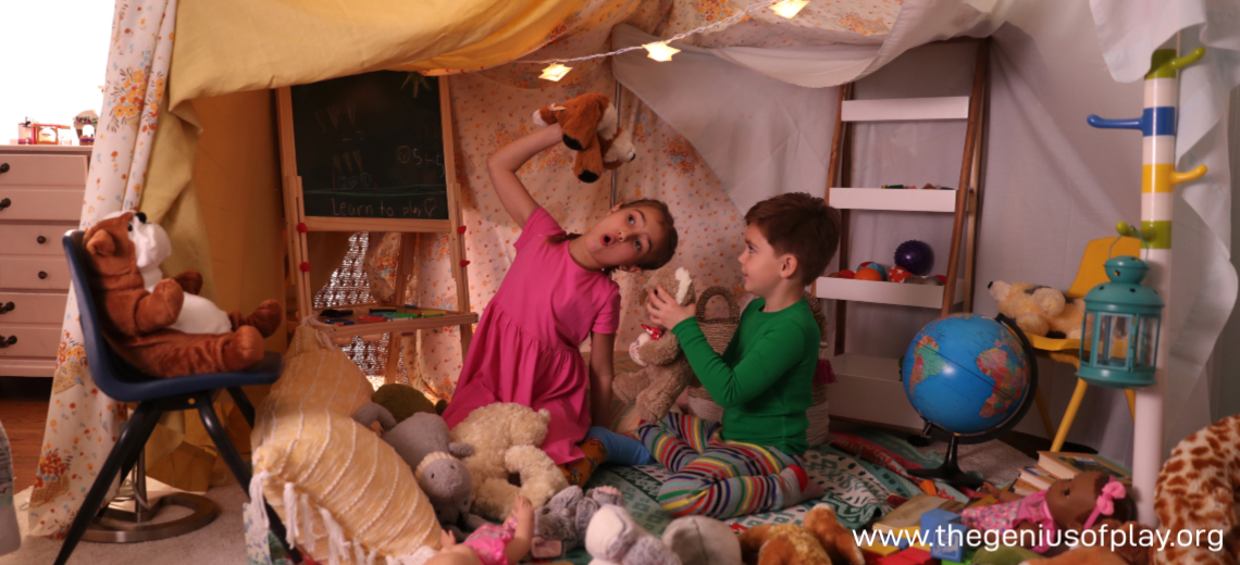 Girl and boy playing in indoor bedroom fort