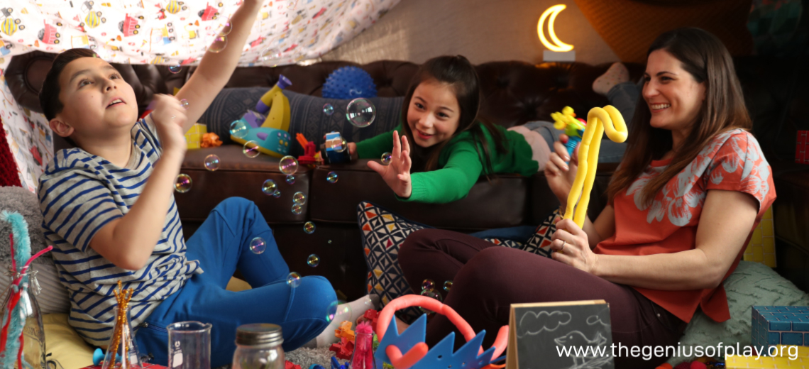 boy, girl and mom playing indoors in a fort