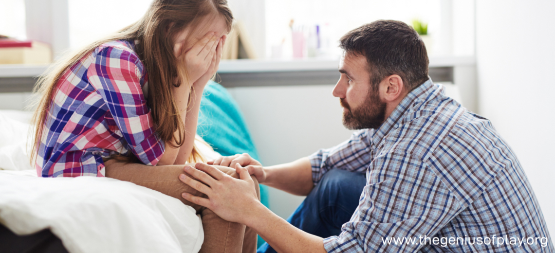 Dad talking to upset young girl