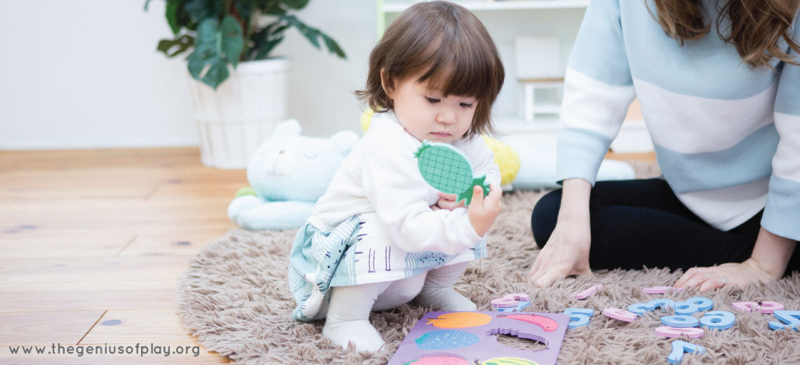 mother overlooking preschooler doing a puzzle