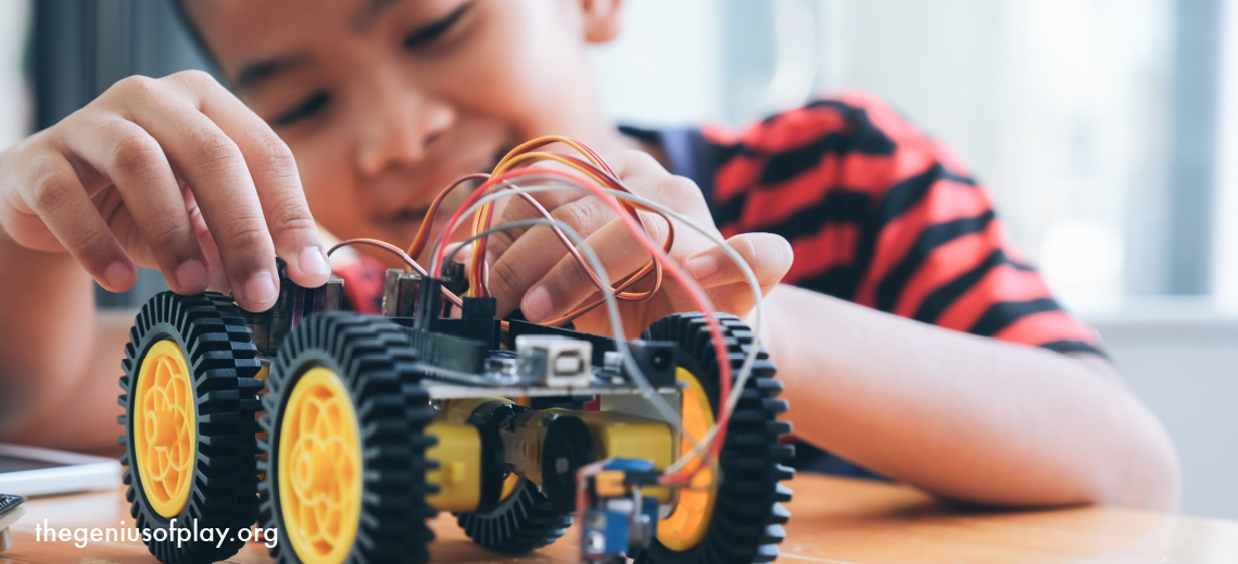 young boy playing with DIY motorized toy truck