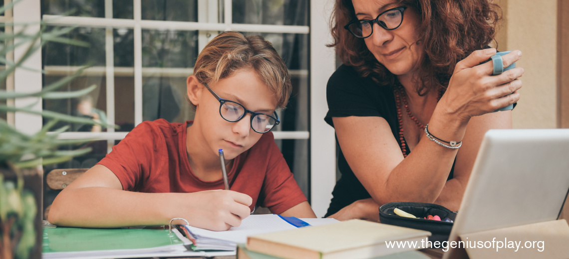 young student doing schoolwork outdoors with books, screen and mom