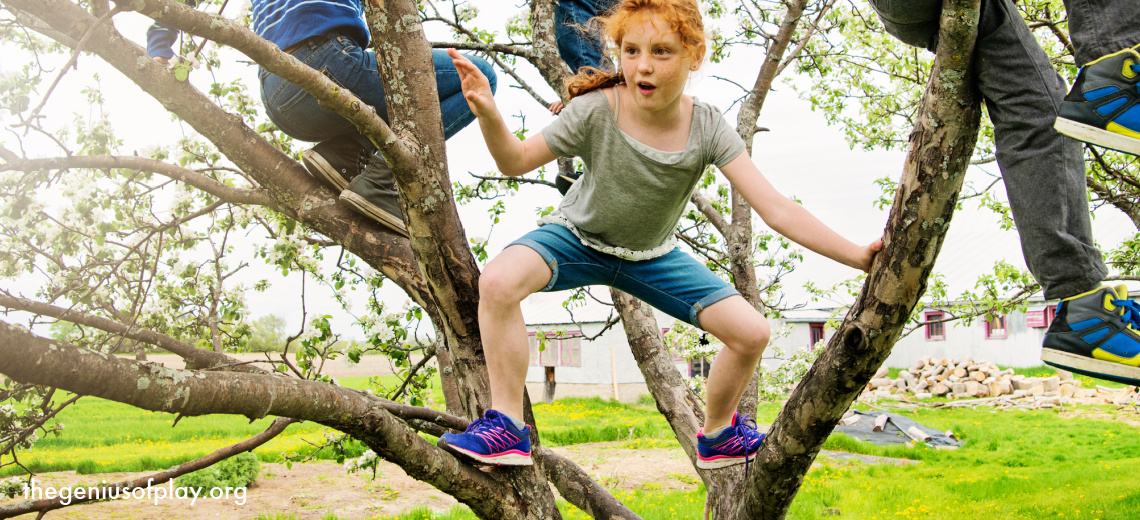 two girls and a boy playing together in the branches of a tree 