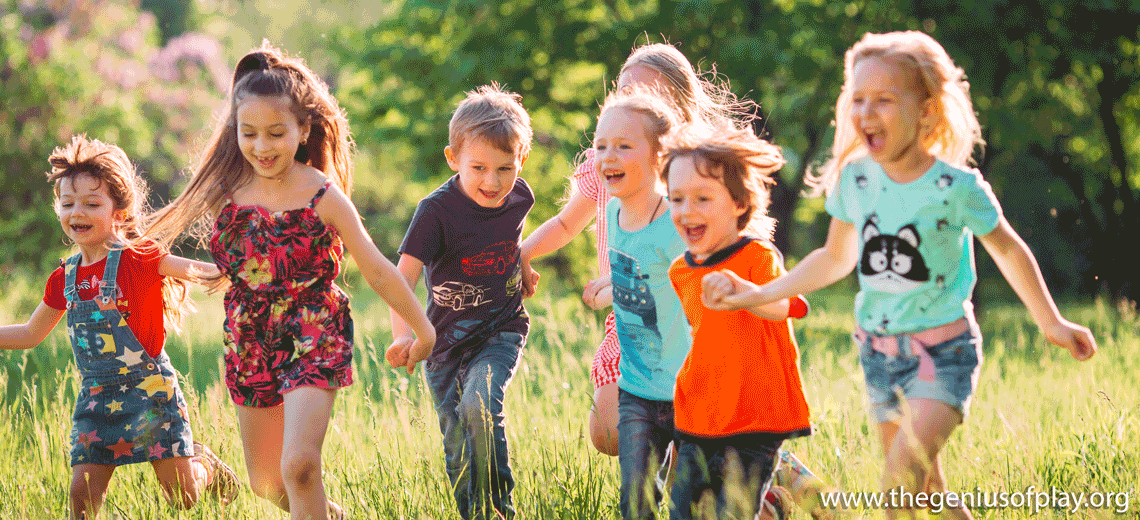 multiple elementary aged kids running through an outdoor field